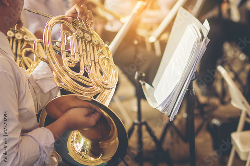 Fotomural musicians playing french horn practice for show in music band.