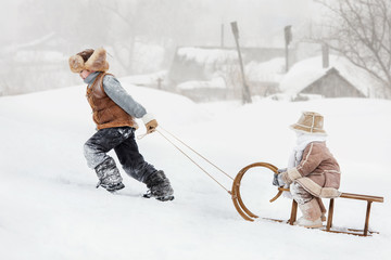 Wall Mural - Children slide down hills on sleds