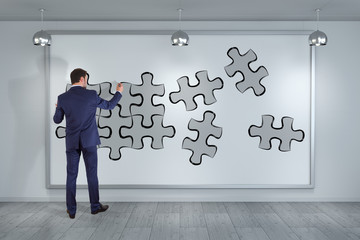 Poster - Businessman searching puzzle solution on a wall 3D rendering