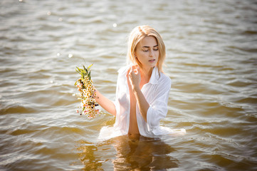 nude portrait of pretty blond girl in white wet shirt
