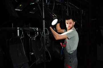 Canvas Print - The stage worker sets up the lights