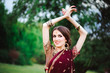 © nagaets - Indian girl with oriental jewellery and make-up henna applied to hand. Brunette Hindu model girl with Indian jewels.