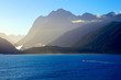 Boat sailing Tasman Sea to Milford Sound in early morning mist