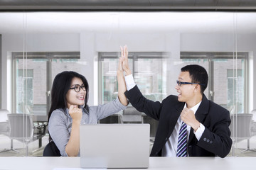 Wall Mural - Business people giving a high five gesture