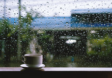 Cup Of Hot Drinks On Wooden Table In Rainy Day