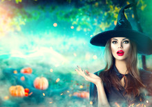 Halloween Witch Pointing Hand Over Dark Magic Field With Pumpkins And Magic Lights In Forest