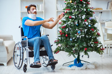 Wall Mural - Injured disabled man celebrating christmas at home