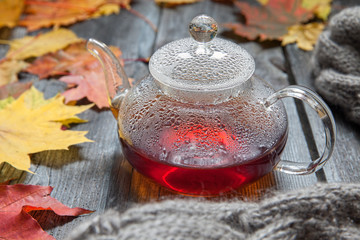 Autumn Still Life: Tea on maple leaves on a wooden table