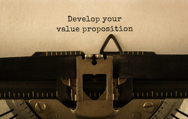 Poster - text develop your value proposition typed on retro typewriter
