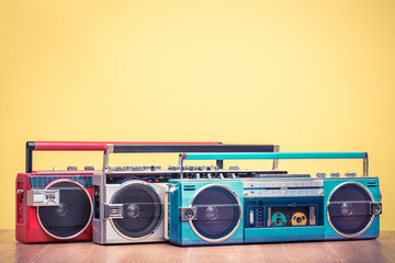 Wall Mural - retro outdated red portable stereo radio cassette recorder from 80s front yellow background. vintage