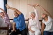 © WavebreakMediaMicro - Senior people stretching while sitting on chairs