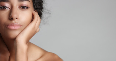 happy serene young woman with beautiful olive skin and curly hair ideal skin and brown eyes