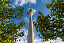 Low-angle View Of The Rhine Tower In Dusseldorf Against A Cloudy Blue Sky