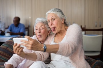 Wall Mural - Senior women making face while taking selfie