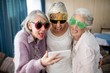 Senior women wearing novelty glasses making face while taking