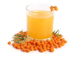 Sea buckthorn juice in a glass with berries isolated on a white background