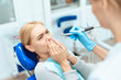© Vadym Huzhva - The woman came to the dental clinic. She sits in the dental chair and afraid