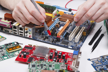Poster - Engineer checking motherboard with multimeter