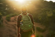 male millennial hiker trekking up trail in southern california during sunset