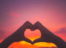 Silhouette Woman Hands To Be Heart Shape On Sunset Background. Happy, Love, Valentine's Day Idea, Sign, Symbol, Concept.