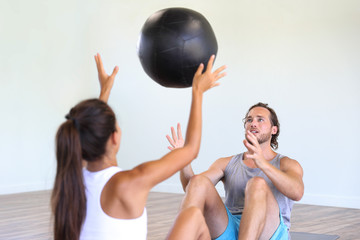 Sticker - Couple training together at gym. Cross training class at fitness centre, two friends working out throwing medicine ball at each other, partner for motivation.