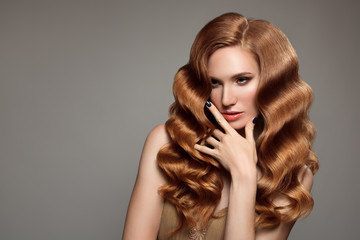 Wall Mural - Portrait of woman with long curly beautiful ginger hair.