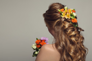 Wall Mural - Close up portrait of young beautiful woman with flowers.