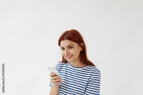 Positive Red Haired Teenage Girl Smiling Cheerfully Enjoying Online Communication Using Free Wireless Internet Connection On Her Generic Electronic Device Staying Connected Always In Touch Buy This Stock Photo And Explore