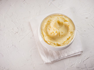 Wall Mural - Mashed potatoes on white concrete background