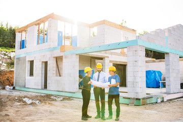 Architects and worker at the construction site.