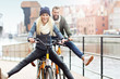 © Kalim - Young couple riding bikes and having fun in the city