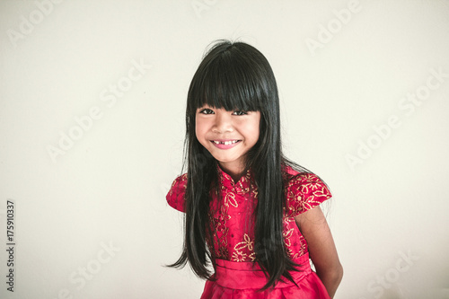 A Cute Asian Kid Girl Wearing Red Chinese Dress For Chinese New