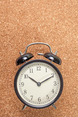 Wall Mural - Black retro alarm clock on wooden background.vertical view with copy space for text