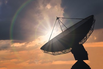 Wall Mural - silhouette of satellite dish or radio antenna at sunset.