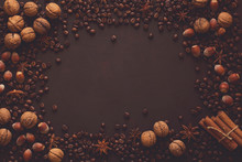 Brown Background With Walnuts, Hazelnuts, Anise, Cinnamon And Coffee Beans