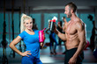© fotoinfot - man and woman with protein shake at gym