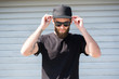 © 4Max - Hipster man wearing black T-shirt and a black hat with space for logo