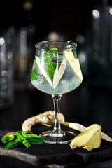 Wall Mural - Ginger cocktail on dark background with mint and ice