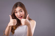 exited woman giving double thumb up studio isolated portrait