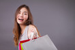happy laughing shopper, woman holding shopping bag isolated