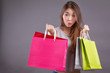 exited, surprised, happy smiling shopper, woman holding shopping bag isolated