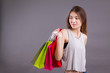 confident shopper looking away, woman holding shopping bag isolated, shopping in style
