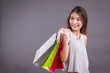 happy smiling shopper, woman holding shopping bag isolated