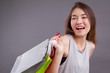 happy laughing shopper, woman holding shopping bag isolated