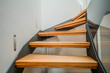 Modern steel staircase with wooden steps in a new apartment in a residential building
