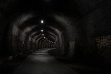 View Into A Dark Old Railway Tunnel, Stretching Into The Distance