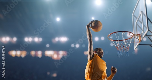 Basketball player performs a slam dunk on a sport background Fototapete