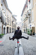 © michela ravasio/Stocksy - Happy man having fun riding a bike