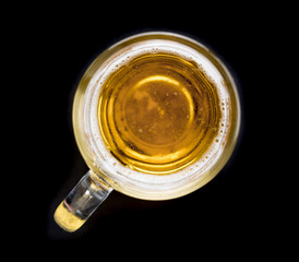 Top view of a glass of beer on black background