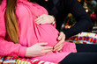 © Nestyda - Beautiful pregnant couple in love on the background of a Christmas tree, having a rest on Christmas holidays before the new year. Big pregnant belly